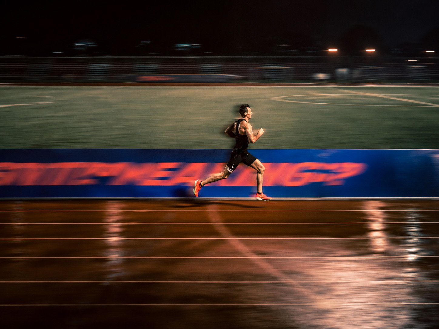 Norman Petermann running on a track at night